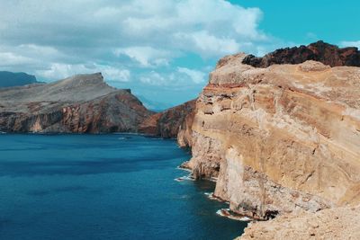 Scenic view of sea and mountains against sky