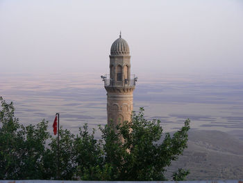 View of tower in city against sky