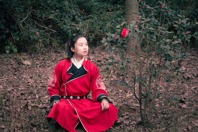 Full length of woman sitting on field