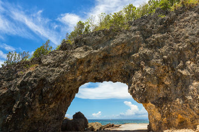 Low angle view of rock formation against sky