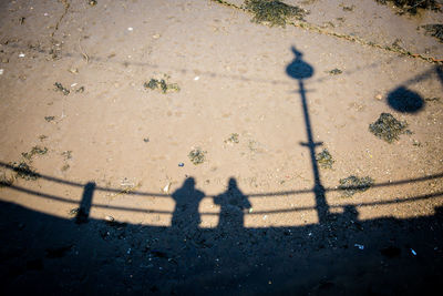 Shadow of people on street in city