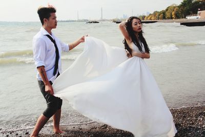 Young couple standing on beach