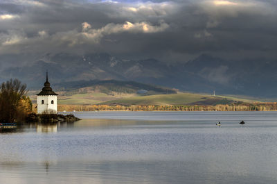 Scenic view of lake against cloudy sky