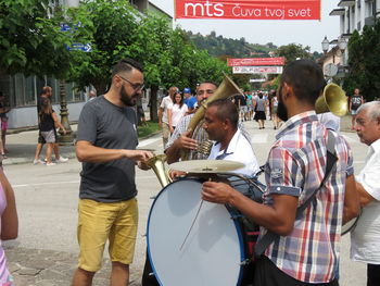 People standing by street in city