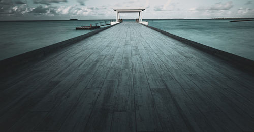 Pier over sea against sky
