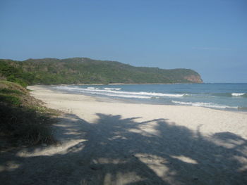 Scenic view of beach against clear sky