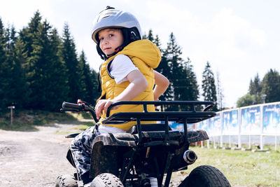 Rear view of boy riding motorcycle