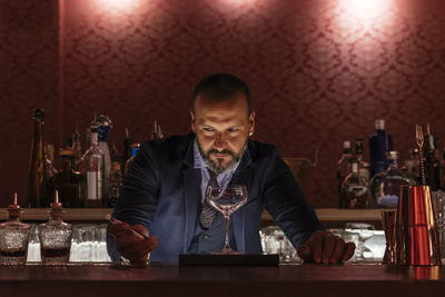 Bartender standing at counter in bar