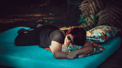 Rear view of woman sleeping in swimming pool