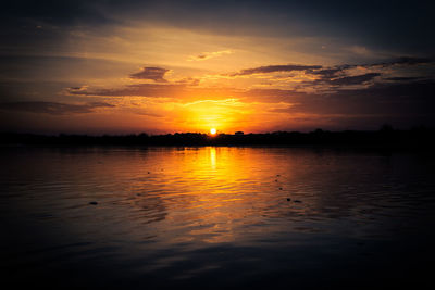 Scenic view of lake against sky during sunset