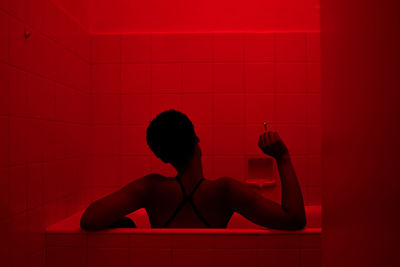 Rear view of woman in bathtub