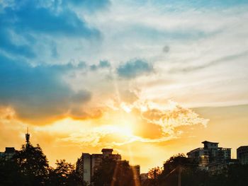 Silhouette buildings against sky during sunset