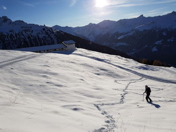 Person snowshoeing on snow covered mountain