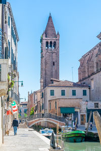 View of buildings against clear blue sky