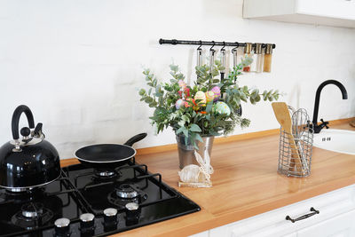 Easter bouquet and eggs on the table in white scandinavian-style kitchen