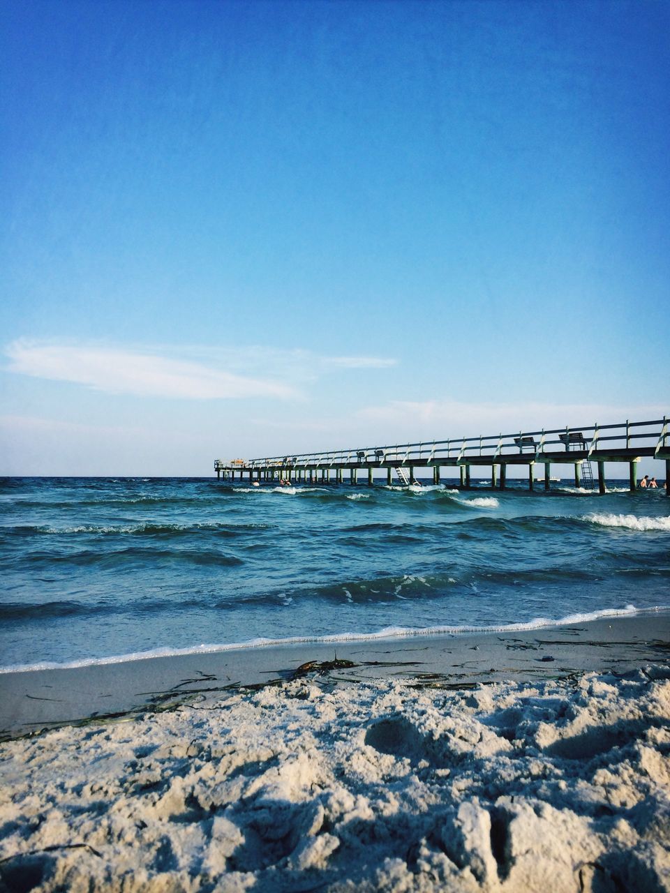 sea, water, beach, horizon over water, shore, scenics, blue, wave, tranquil scene, beauty in nature, tranquility, sky, surf, nature, copy space, pier, rock - object, sand, clear sky, idyllic