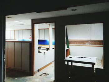 Empty chairs and table in abandoned building