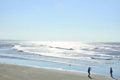 Scenic view of beach against clear sky