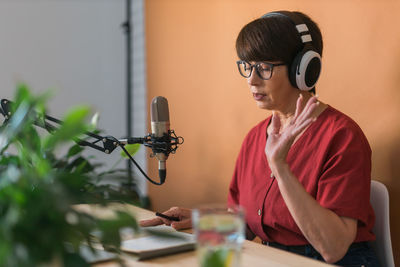 Woman podcasting at studio