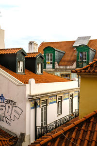 Low angle view of buildings in town against sky