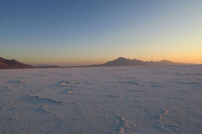 Scenic view of land against sky during sunset