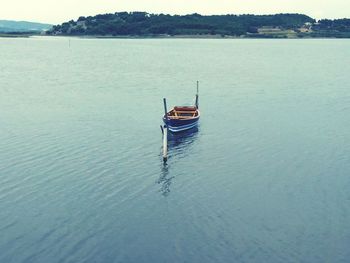 Boat moored on sea against sky