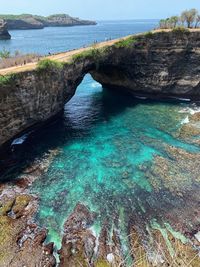 Scenic view of sea against rock formation