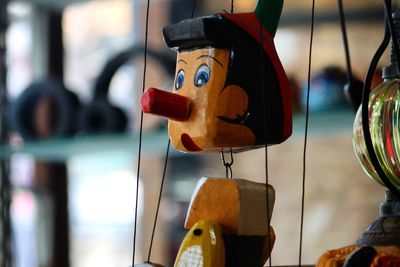 Close-up of toys hanging in store for sale