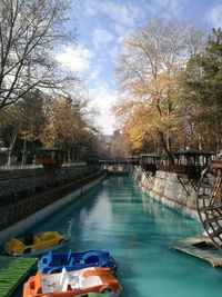 Canal by swimming pool against sky