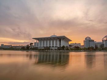 Reflection of building in lake during sunset