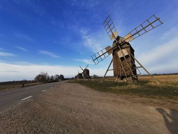 Traditional windmill on field against sky