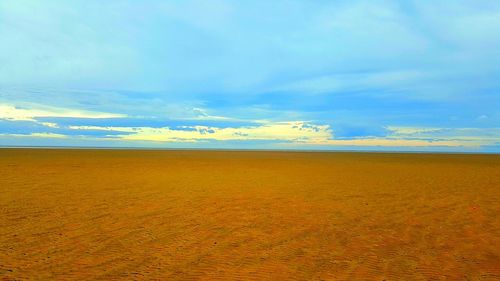 Scenic view of calm sea against blue sky