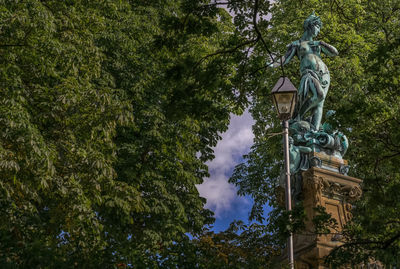 Low angle view of statue against trees