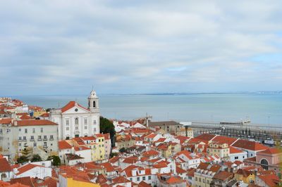 Townscape by sea against sky