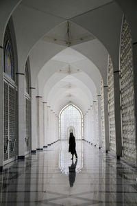 Woman walking in corridor of building