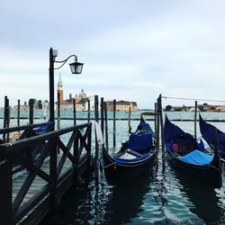 Gondolas moored on grand canal in city