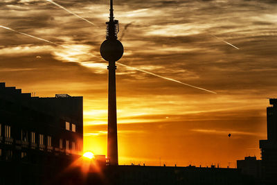 Low angle view of communications tower at sunset