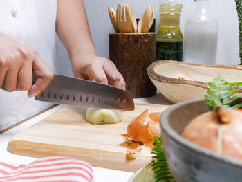 Midsection of woman preparing food on cutting board