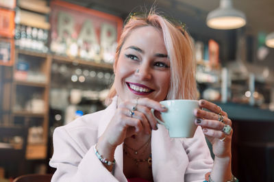 Young woman is drinking coffee in a cafe.