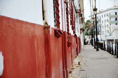 Footpath amidst buildings in city