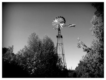 Low angle view of windmill against clear sky