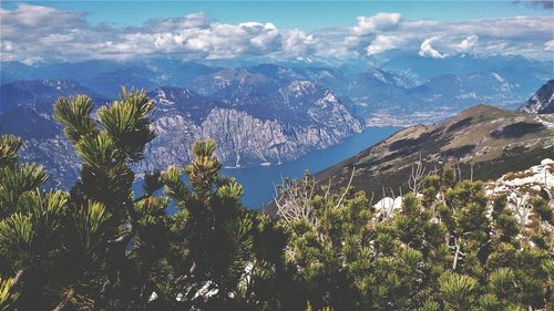 Scenic view of trees and mountains against sky