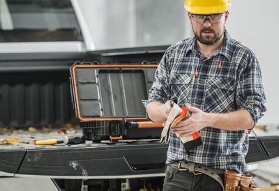 Midsection of man working in workshop