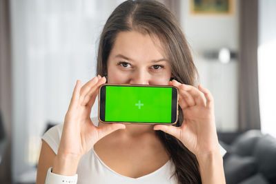 Portrait of young woman using mobile phone