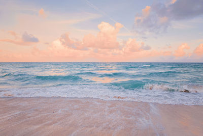 Sea ocean beach sunset sunrise landscape. water wave with foam.  sunset airy red sky with clouds