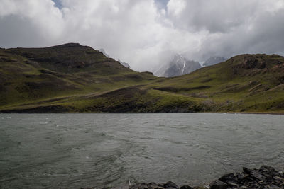 Scenic view of mountains against cloudy sky