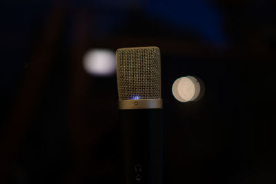 Close-up of microphone against black background