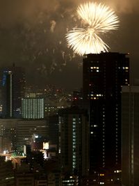 Firework display in city at night