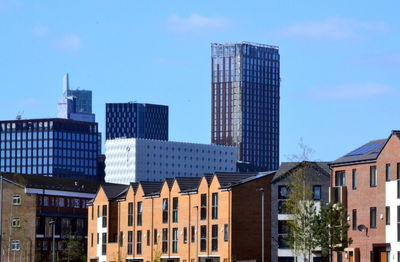 Low angle view of buildings in city against sky