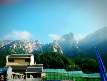 Scenic view of mountains against blue sky